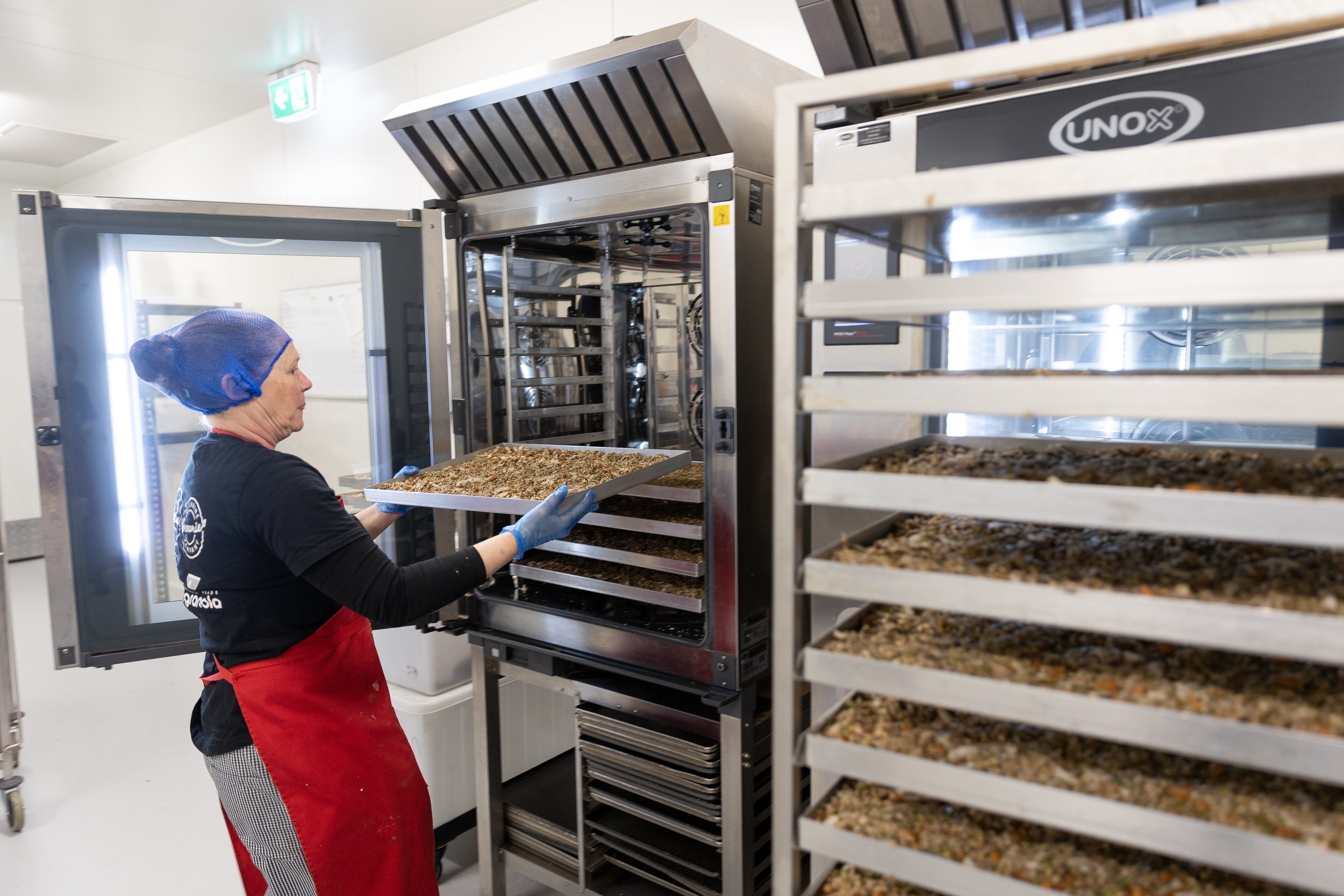 Granola tray being placed into oven